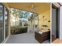 Relaxing screened-in patio with comfortable seating and a ceiling fan, offering a serene outdoor space at 2000 Bal Harbor Blvd # 1-111, Punta Gorda, FL 33950