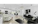 Bright, open-concept living space featuring modern decor, sleek lighting, and seamless flow to the dining area at 2325 Hanford Ln, North Port, FL 34288