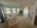 Bright and airy living room filled with natural light and sliding glass door access to the outdoors at 432 Olivia Rd, Venice, FL 34293