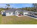 Well maintained home with a front lawn, driveway, and a large area to park an RV or boat at 11338 Willmington Blvd, Port Charlotte, FL 33981