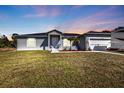 Beautifully kept home features a lawn and clean exterior with parking for an RV or boat at 11338 Willmington Blvd, Port Charlotte, FL 33981