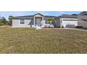 Well maintained home with a manicured front lawn, driveway, and a clean exterior at 11338 Willmington Blvd, Port Charlotte, FL 33981