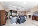Open-concept living room with tile flooring, tray ceiling, and seamless access to the outdoor patio at 17122 Barcrest Ln, Punta Gorda, FL 33955