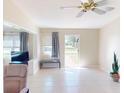 Bright and airy living room featuring tile floors, neutral paint, and large windows with views of the outdoors at 21456 Holdern Ave, Port Charlotte, FL 33952
