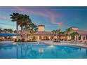 Stunning pool with lounge chairs and palm trees at the clubhouse for a relaxing resort-style atmosphere at 2478 Brassica Dr, North Port, FL 34289