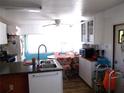 Bright kitchen with a breakfast nook, plenty of storage, and modern sink fixtures at 5233 Palena Blvd, North Port, FL 34287