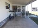 Covered patio space with seating and a bicycle, perfect for relaxing outdoors at 5233 Palena Blvd, North Port, FL 34287