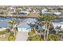 Aerial view of light blue home with lush landscaping and a backyard canal at 960 Messina Dr, Punta Gorda, FL 33950