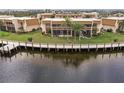 Exterior view of condos overlooking water with a dock at 1080 Bal Harbor Blvd # 4D, Punta Gorda, FL 33950