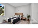 Serene bedroom with natural light, a minimalist decor, and a comfortable bed, creating a calming space at 1117 Vernon Ave, Port Charlotte, FL 33948