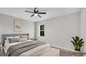 Bright bedroom featuring neutral decor, a ceiling fan, and a comfortable bed for a relaxing space at 1117 Vernon Ave, Port Charlotte, FL 33948