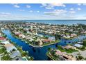 Aerial shot showcases this charming neighborhood with waterfront properties and canal access to the open bay at 1118 Treasure Cay Ct, Punta Gorda, FL 33950