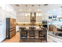 Bright kitchen with stainless steel appliances, stone countertops, island seating, and ample cabinet storage at 11723 1St E St, Treasure Island, FL 33706