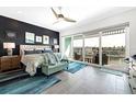 Main bedroom suite features a private balcony with water views and modern decor, offering a serene retreat at 11723 1St E St, Treasure Island, FL 33706
