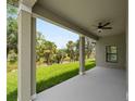 Enjoy the covered outdoor patio with ceiling fan and scenic views of the backyard at 1790 New London St, North Port, FL 34288
