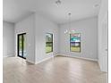 Bright dining room with neutral walls, tile floors, and a modern chandelier at 1818 New London St, North Port, FL 34288