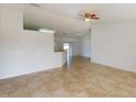 Bright living area with neutral walls, tile flooring, and ceiling fan fixture at 20370 Mount Prospect Ave, Port Charlotte, FL 33952