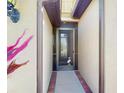 Close up of a cozy and inviting entryway featuring brick details and a decorative security door at 2444 Daisy Dr, North Port, FL 34289