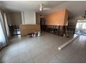 Spacious living room featuring tile floors, ceiling fan, and natural light, ready for renovation at 3120 Wisteria Pl, Punta Gorda, FL 33950