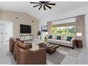 Bright living room featuring tile floors, modern furniture and a large window with outdoor views at 626 Lomond Dr, Port Charlotte, FL 33953