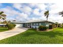 Charming single-Gathering home showcasing a well-manicured lawn, lovely landscaping, and an attached garage at 936 Lassino Ct, Punta Gorda, FL 33950