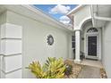 Covered entryway with stucco walls, decorative accents, and a charming front door at 2153 Boxwood St, North Port, FL 34289
