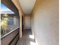 Covered front entrance with tiled flooring and neutral paint provides a welcoming entry at 2281 Tolbert St, Port Charlotte, FL 33948