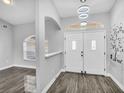 Inviting entryway with stylish double doors, glossy floors, and modern light fixtures at 23227 Adela Ave, Port Charlotte, FL 33952