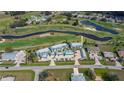 Aerial view of condo complex next to golf course and waterways in a residential neighborhood at 1340 San Cristobal Ave # 305, Punta Gorda, FL 33983