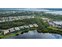 Community aerial view showcasing lush greenery, beautiful lakes, and diverse home styles at 14455 Silver Lakes Cir, Port Charlotte, FL 33953