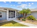 Charming front entrance with a screened entryway, a decorative fountain, and beautiful landscaping in a tranquil setting at 27191 Tierra Del Fuego Cir, Punta Gorda, FL 33983