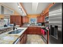 Well-equipped kitchen featuring granite countertops, stainless steel appliances, and ample cabinet space at 29175 River Dr, Punta Gorda, FL 33982