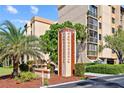 Exterior shot of the community sign surrounded by lush landscaping and a well-maintained building at 3006 Caring Way # 431, Port Charlotte, FL 33952