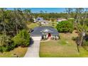 Charming exterior of home with a well-manicured lawn, concrete driveway, and inviting landscaping at 4462 La France Ave, North Port, FL 34286