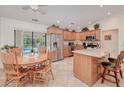 Open kitchen featuring stainless steel appliances, granite countertops, an island, and wood cabinetry at 4520 Knollwood Dr, Punta Gorda, FL 33982