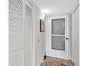 Hallway with white doors, cabinets, and a view to the front door at 601 Shreve St # 13A, Punta Gorda, FL 33950