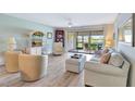 Bright living room with hardwood floors and sliding glass doors to screened lanai at 601 Shreve St # 13A, Punta Gorda, FL 33950