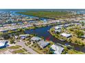 Aerial view showcasing the home's waterfront location, private dock, and serene canal setting at 120 Buckeye Nw Ave, Port Charlotte, FL 33952