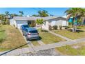 Charming home with mature landscaping, a two-car garage, and a spacious front yard at 120 Buckeye Nw Ave, Port Charlotte, FL 33952