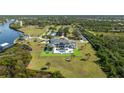 Luxury estate featuring a pool, expansive lawn, tennis court and waterfront access at 13000 Windcrest Dr, Port Charlotte, FL 33953