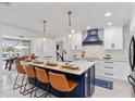 Island with seating, pendant lights, modern cabinetry, and stainless steel appliances at 1301 Appian Dr, Punta Gorda, FL 33950
