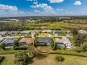 Aerial view of home with lush green surroundings, pool, and screened-in lanai at 25853 Aysen Dr, Punta Gorda, FL 33983