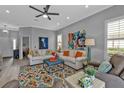 Inviting living room with colorful rug, stylish furniture, and a relaxing ambiance for entertaining or unwinding at 2892 Myakka Creek Ct, Port Charlotte, FL 33953