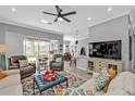 Bright, open living room featuring neutral walls, a ceiling fan, and comfortable seating, creating a cozy atmosphere at 2892 Myakka Creek Ct, Port Charlotte, FL 33953