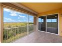 Relax on this tiled balcony with aluminum railings and a lovely view of the green landscape at 17495 Boca Vista Rd # 6, Punta Gorda, FL 33955