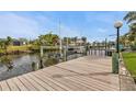 Exterior view of the home's private boat dock, with a covered lift, on a canal at 18536 Alphonse Cir, Port Charlotte, FL 33948