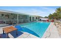 Lovely pool and patio area with outdoor seating, complemented by a screened lanai and boat dock at 21184 Edgewater Dr, Port Charlotte, FL 33952