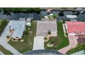 Waterfront property showcases expansive lawn, boat dock, and prime canal access, set in a friendly community at 240 Riviera Ct, Punta Gorda, FL 33950