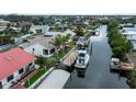 Waterfront home boasts private dock with boat, canal access, and lush landscaping in a serene neighborhood at 240 Riviera Ct, Punta Gorda, FL 33950