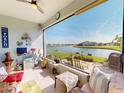 Relaxing porch with a scenic lake view, perfect for outdoor enjoyment and watching the sunset at 24313 Westgate Blvd, Punta Gorda, FL 33980